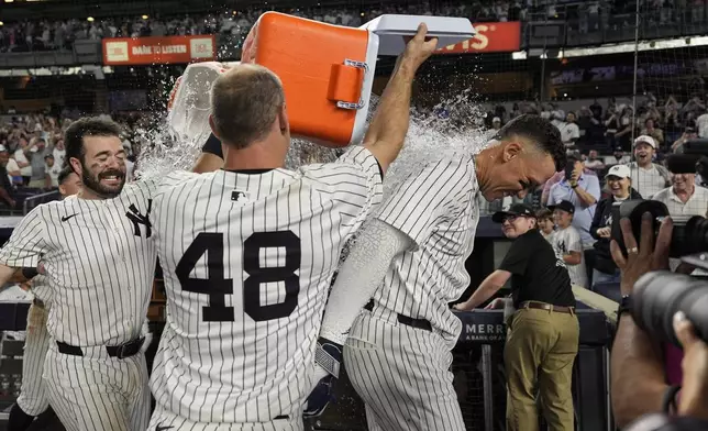 New York Yankees players throw Gatorade on designated hitter Aaron Judge after winning a baseball game against the Seattle Mariners, Thursday, July 10, 2025, in New York. (AP Photo/Yuki Iwamura)