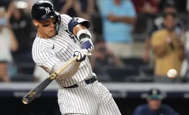 New York Yankees designated hitter Aaron Judge hits a sacrifice fly during the 10th inning of a baseball game against the Seattle Mariners, Thursday, July 10, 2025, in New York. (AP Photo/Yuki Iwamura)