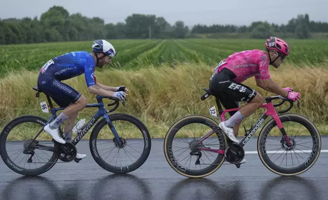 Italy's Vincenzo Albanese, right, and France's Quentin Pacher pedal during the seventeenth stage of the Tour de France cycling race over 160.4 kilometers (99.7 miles) with start in Bollene and finish in Valence, France, Wednesday, July 23, 2025. (AP Photo/Mosa'ab Elshamy)