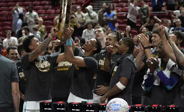 Charlotte Hornets players celebrate after defeating the Sacramento Kings in an NBA Summer League championship basketball game Sunday, July 20, 2025, in Las Vegas. (AP Photo/John Locher)