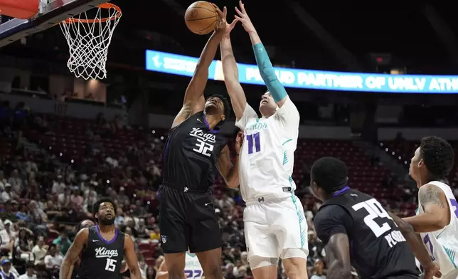 Sacramento Kings' Dylan Cardwell, left, and Charlotte Hornets' Ryan Kalkbrenner battle for a rebound during the first half of an NBA Summer League championship basketball game Sunday, July 20, 2025, in Las Vegas. (AP Photo/John Locher)