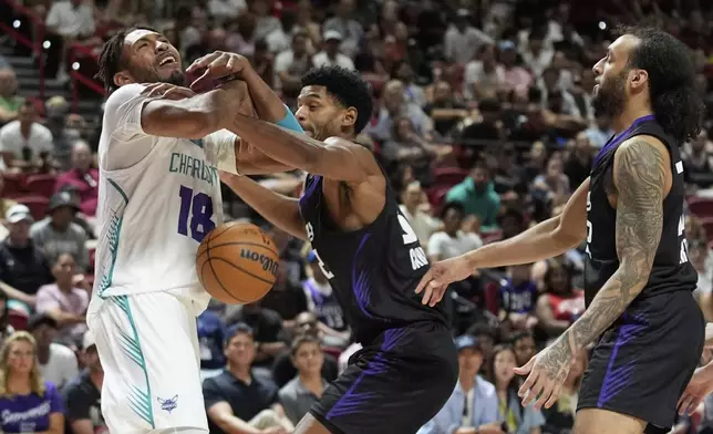 Sacramento Kings' Dylan Cardwell fouls Charlotte Hornets' James Banks III during the first half of an NBA Summer League championship basketball game Sunday, July 20, 2025, in Las Vegas. (AP Photo/John Locher)