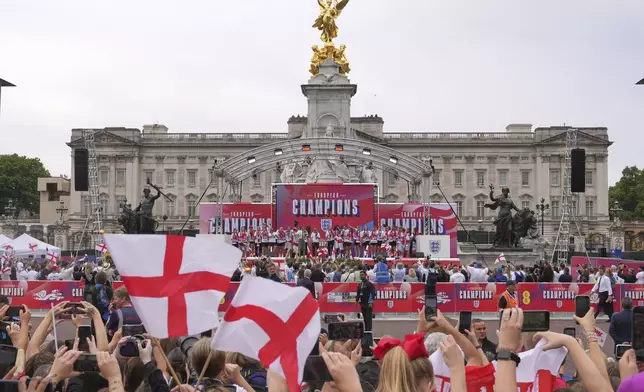 England's soccer players celebrate with fans during a ceremony on a stage in front of Buckingham Palace in central London, Tuesday, July 29, 2025 after their victory in the Women's EURO 2025 final.(AP Photo/Kin Cheung)