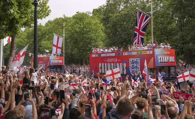 England's soccer players celebrate with fans during an open-top bus procession and ceremony in central London, Tuesday, July 29, 2025 after their victory in the Women's EURO 2025 final.(AP Photo/Kin Cheung)