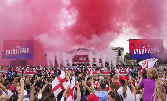 England's soccer players celebrate with fans during a ceremony on a stage in front of Buckingham Palace in central London, Tuesday, July 29, 2025 after their victory in the Women's EURO 2025 final.(AP Photo/Kin Cheung)