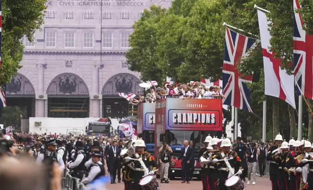 England's soccer players celebrate with fans during an open-top bus procession and ceremony in central London, Tuesday, July 29, 2025 after their victory in the Women's EURO 2025 final.(AP Photo/Joanna Chan)