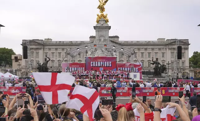 England's soccer players celebrate with fans during a ceremony on a stage in front of Buckingham Palace in central London, Tuesday, July 29, 2025 after their victory in the Women's EURO 2025 final.(AP Photo/Kin Cheung)