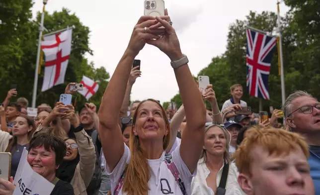 England's soccer fans celebrate during an open-top bus procession and ceremony in central London, Tuesday, July 29, 2025 after their victory in the Women's EURO 2025 final.(AP Photo/Joanna Chan)