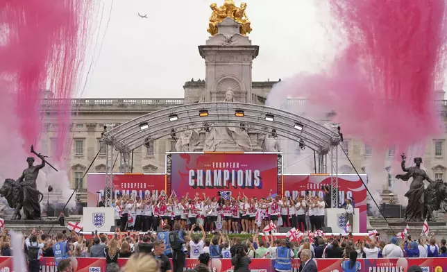England's soccer players celebrate with fans during a ceremony on stage in front of Buckingham Palace in central London, Tuesday, July 29, 2025 after their victory in the Women's EURO 2025 final.(AP Photo/Kin Cheung)