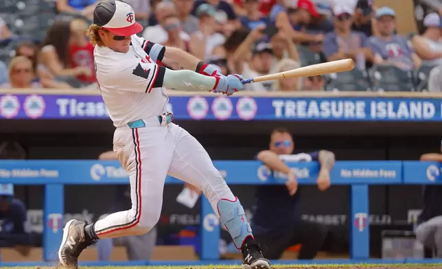 Minnesota Twins' Harrison Bader hits a winning solo home run against the Tampa Bay Rays to end a baseball game Friday, July 4, 2025, in Minneapolis. (AP Photo/Bruce Kluckhohn)