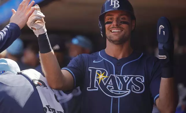 Tampa Bay Rays' Joshua Lowe celebrates after his run against the Minnesota Twins on a double by Yandy Diaz in the sixth inning of a baseball game Friday, July 4, 2025, in Minneapolis. (AP Photo/Bruce Kluckhohn)