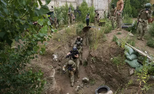 Ukrainian 3rd Assault Brigade recruits train at the polygon in Kyiv region, Ukraine, on Wednesday, July 16, 2025. (AP Photo/Evgeniy Maloletka)