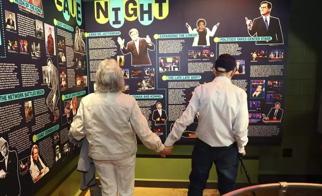 Mario and Gail Cirasunda, of Orchard Park, N.Y., look at exhibits from past and current comedy stars on display during a Memory Cafe event at the National Comedy Center Monday, May 5, 2025, in Jamestown, N.Y. (AP Photo/Jeffrey T. Barnes)