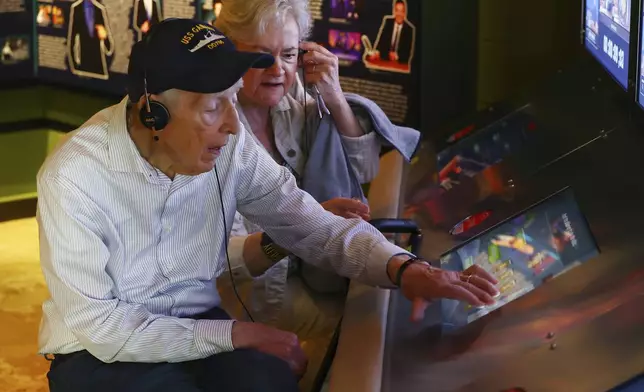 Mario and Gail Cirasunda, of Orchard Park, N.Y., interact with one of the museum's touch screen exhibits during a Memory Cafe event at the National Comedy Center Monday, May 5, 2025, in Jamestown, N.Y. (AP Photo/Jeffrey T. Barnes)