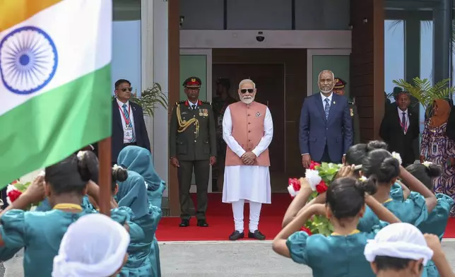 Indian Prime Minister Narendra Modi, center, and Maldives President Mohamed Muizzu, center right, watch a traditional welcome dance upon Modi's arrival at the airport, in Male, Maldives, Friday, July 25, 2025. (Indian Prime Ministers Office via AP)
