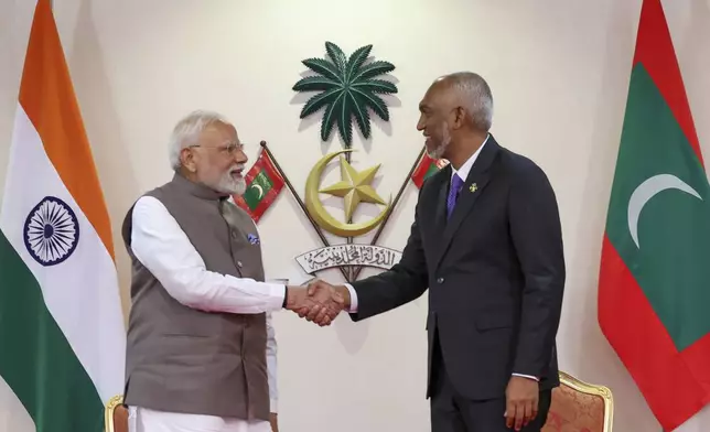 President of the Maldives Mohamed Muizzu, right, shakes hand with Indian Prime Minister Narendra Modi after signing a memorandum of understanding between the two countries in Male, Maldives, Friday, July 25, 2025. (Indian Prime Ministers Office via AP)