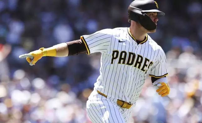 San Diego Padres' Gavin Sheets points towards his dugout after hitting a two-run home run against the New York Mets in the third inning of a baseball game Wednesday, July 30, 2025, in San Diego. (AP Photo/Derrick Tuskan)