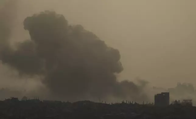 Smoke from an Israeli bombardment billows over the Gaza Strip, seen from southern Israel, Tuesday, July 1, 2025. (AP Photo/Ariel Schalit)