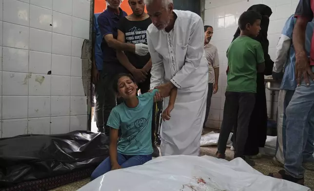 Palestinian girl Rafeef Abu Ghaly mourns the loss of her grandparents, who were killed in an Israeli airstrike on Al-Zawaideh, at Al-Aqsa Hospital morgue in Deir al-Balah, Gaza Strip, on Tuesday, July 1, 2025. (AP Photo/Abdel Kareem Hana)