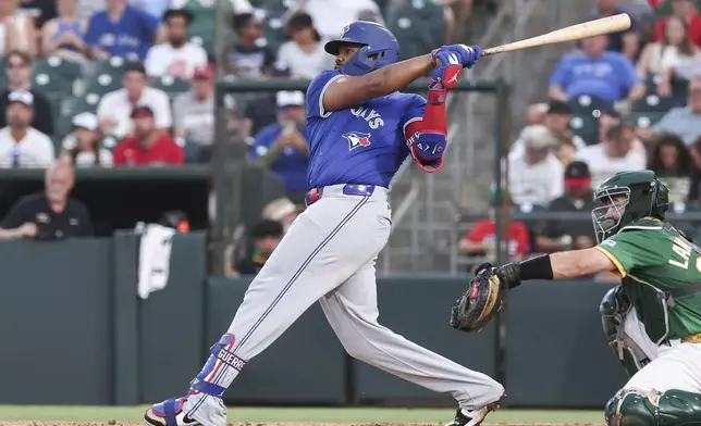 Toronto Blue Jays' Vladimir Guerrero Jr. singles in the fifth inning for his 1,000th career hit during a baseball game against the Athletics, Friday, July 11, 2025, in West Sacramento, Calif. (AP Photo/Sara Nevis)