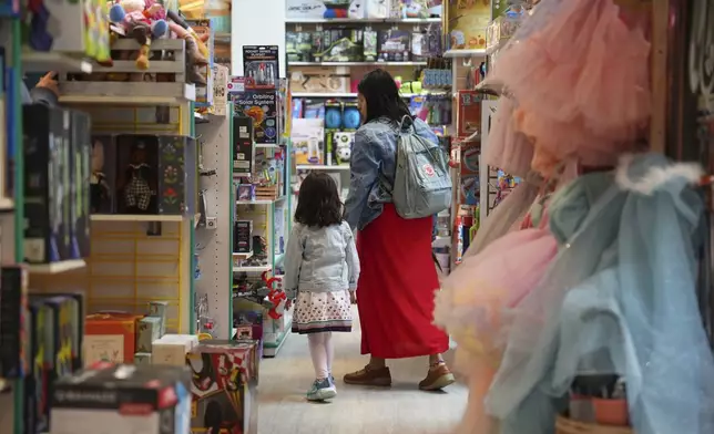 A family shops in a JaZams toy store Friday, June 27, 2025, in Princeton, N.J. (AP Photo/Matt Slocum)