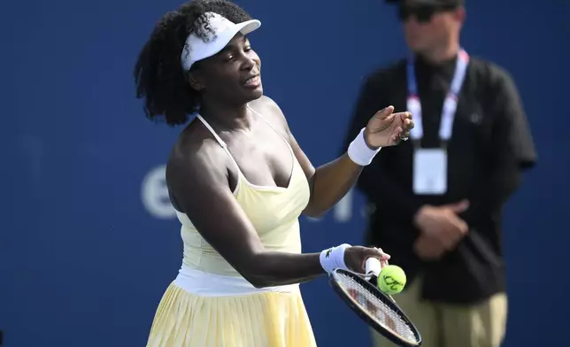 Venus Williams hits a ball toward the crowd after a doubles match with Hailey Baptiste against Eugenie Bouchard and Clervie Ngounoue at the Citi Open tennis tournament Monday, July 21, 2025, in Washington. (AP Photo/Nick Wass)