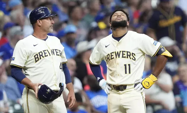 Milwaukee Brewers' Jackson Chourio (11) reacts after suffering an injury during the fifth inning of a baseball game against the Chicago Cubs, Tuesday, July 29, 2025, in Milwaukee. (AP Photo/Aaron Gash)