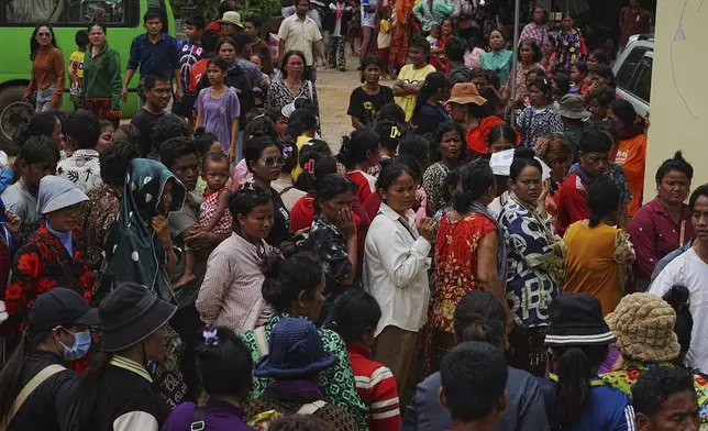 Local villagers wait to receive supplies donated by a charity, in Wat Phnom Kamboar, Oddar Meanchey province, Cambodia, Sunday, July 27, 2025, amid the fighting between Thailand and Cambodia. (AP Photo/Heng Sinith)