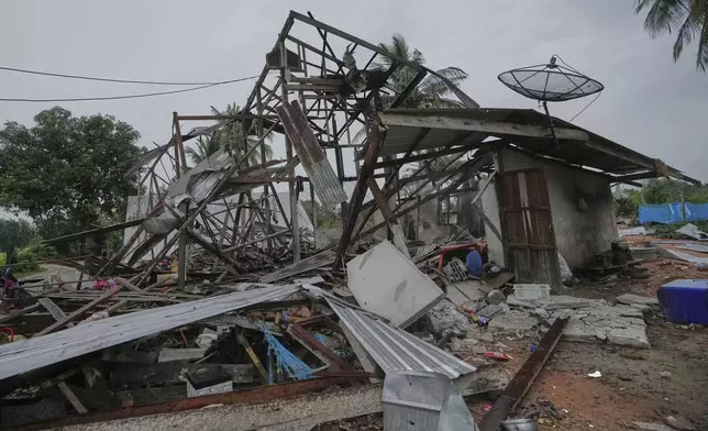 A house is seen damaged after Cambodia fired artillery shells in Surin Province, Thailand, Sunday, July 27, 2025. (AP Photo/Sakchai Lalit)