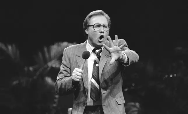 FILE - Members of the audience react to evangelist Jimmy Swaggart during a recent rally in Milwaukee, Feb. 10, 1985. (AP Photo/Joseph Jensen Jr, file)