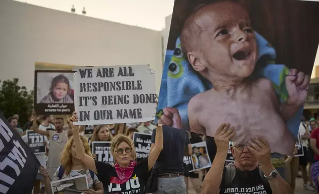 Israeli activists take part in a protest against the war in the Gaza Strip, Israel's measures regarding food distribution and the forced displacement of Palestinians, in Tel Aviv, Israel, Tuesday, July 22, 2025. (AP Photo/Ohad Zwigenberg)