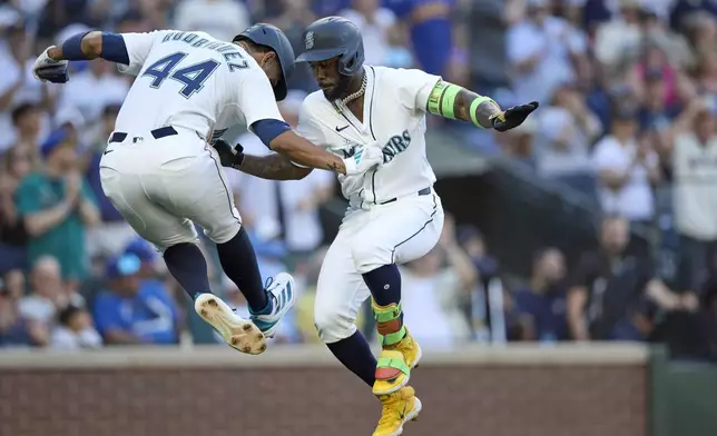 Seattle Mariners' Randy Arozarena, right, celebrates at home with Julio Rodríguez, left, after hitting a three-run home run off Kansas City Royals starting pitcher Michael Wacha During the fifth inning of a baseball game Monday, June 30, 2025, in Seattle. (AP Photo/John Froschauer)