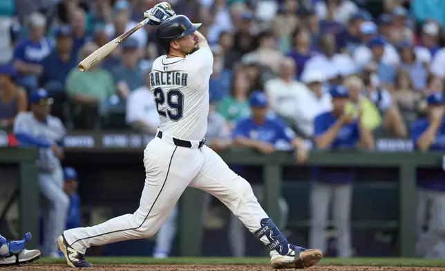 Seattle Mariners' Cal Raleigh follows through on a solo home run off Kansas City Royals pitcher Daniel Lynch IV during the seventh inning of a baseball game Monday, June 30, 2025, in Seattle. (AP Photo/John Froschauer)