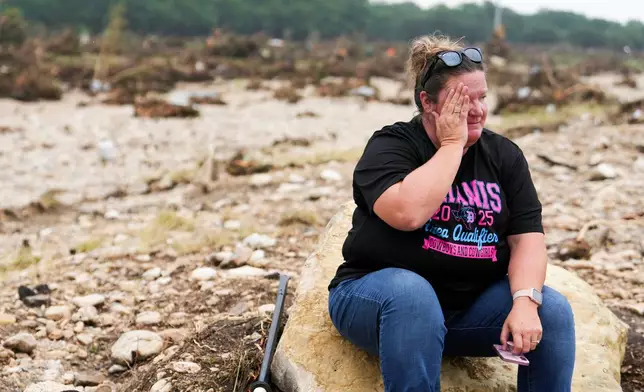 Marissa Zachry takes a moment while searching for survivors along the Guadalupe River on Sunday, July 6, 2025, in Hunt, Texas. (Jason Fochtman/Houston Chronicle via AP)
