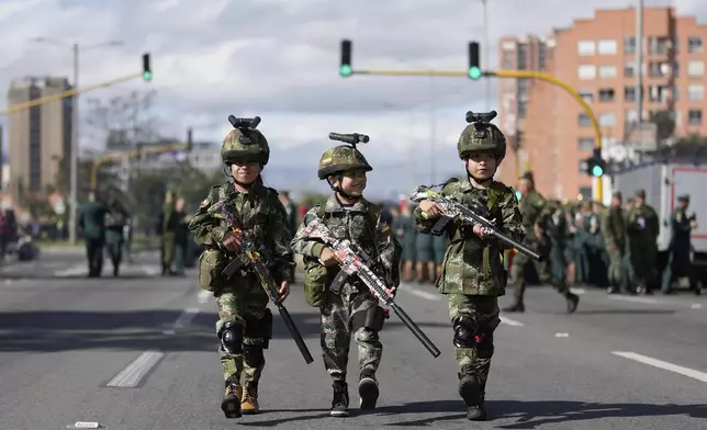 Children dressed as soldiers march during an Independence Day military parade in Bogota, Colombia, Sunday, July 20, 2025. (AP Photo/Fernando Vergara)