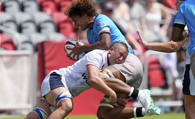 Tahlia Brody of the U.S., left, tackles Fiji's Alfreda Fisher during the women's rugby union international between Fiji and the USA at Audi Field in Washington, Saturday, July 19, 2025. (AP Photo/Alex Brandon)