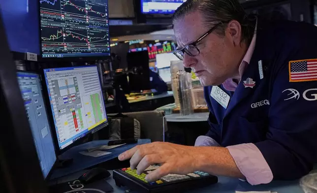 Specialist Gregg Maloney works at his post on the floor of the New York Stock Exchange, Tuesday, July 1, 2025. (AP Photo/Richard Drew)