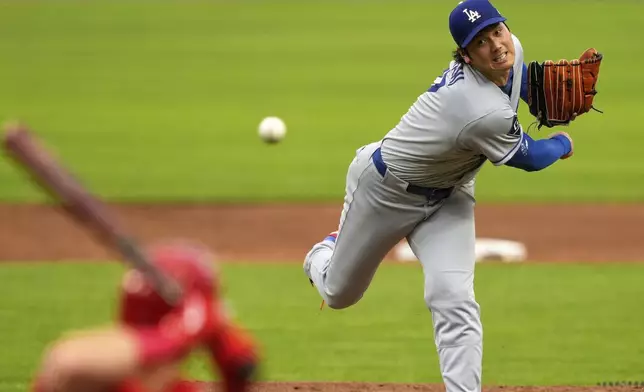Los Angeles Dodgers' Shohei Ohtani throws during the third inning of a baseball game against the Cincinnati Reds Wednesday, July 30, 2025, in Cincinnati. (AP Photo/Carolyn Kaster)