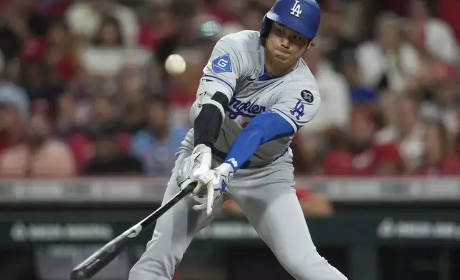 Los Angeles Dodgers' Shohei Ohtani flies out during the eighth inning of a baseball game against the Cincinnati Reds Wednesday, July 30, 2025, in Cincinnati. (AP Photo/Carolyn Kaster)