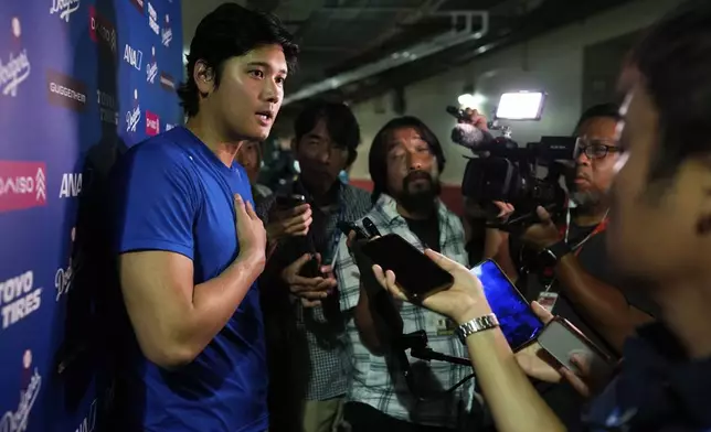 Los Angeles Dodgers' Shohei Ohtani talks to the media after a baseball game against the Cincinnati Reds Wednesday, July 30, 2025, in Cincinnati. (AP Photo/Carolyn Kaster)