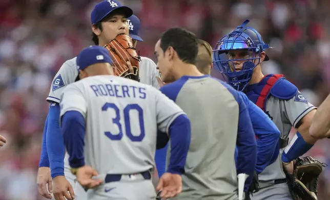 Los Angeles Dodgers' Shohei Ohtani is taken out of the game during the fourth inning of a baseball game against the Cincinnati Reds Wednesday, July 30, 2025, in Cincinnati. (AP Photo/Carolyn Kaster)