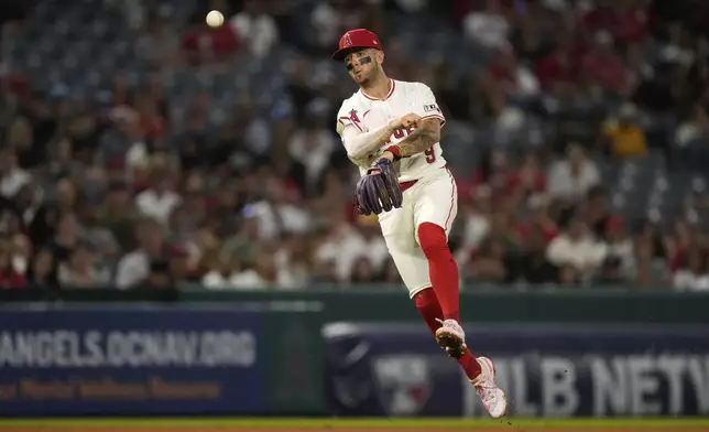 Los Angeles Angels shortstop Zach Neto throws out Texas Rangers' Kyle Higashioka during the sixth inning of a baseball game Wednesday, July 30, 2025, in Anaheim, Calif. (AP Photo/Mark J. Terrill)