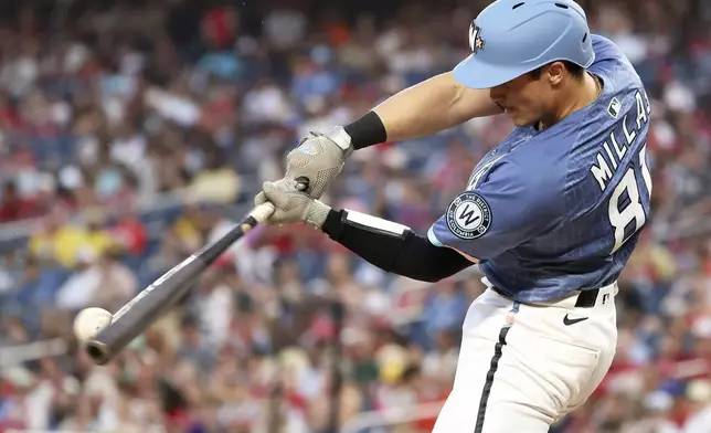 Washington Nationals' Drew Millas hits an RBI single during the second inning of a baseball game against the San Diego Padres, Saturday, July 19, 2025, in Washington. (AP Photo/Daniel Kucin Jr.)