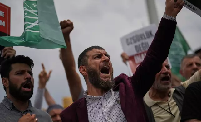 People shout slogans during a protest against satirical LeMan magazine after they published a cartoon that allegedly depicted the Prophet Muhammad, outside Taksim mosque, in Istanbul, Turkey, Tuesday, July 1, 2025. (AP Photo/Francisco Seco)