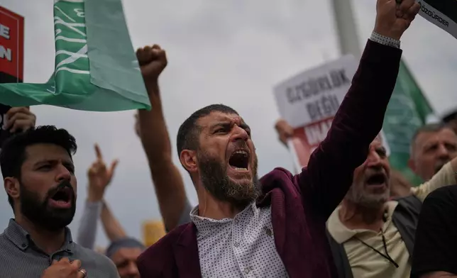 People shout slogans during a protest against satirical LeMan magazine after they published a cartoon that allegedly depicted the Prophet Muhammad, outside Taksim mosque, in Istanbul, Turkey, Tuesday, July 1, 2025. (AP Photo/Francisco Seco)
