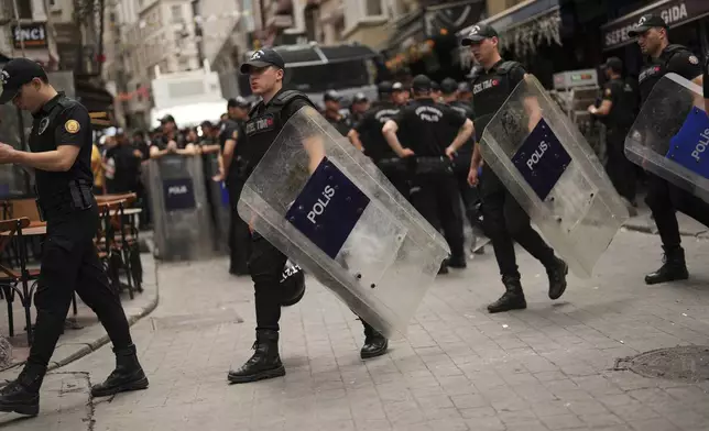 Police officers take position prior to a protest against satirical LeMan magazine after they published a cartoon that allegedly depicted the Prophet Muhammad, in Istanbul, Turkey, Tuesday, July 1, 2025. (AP Photo/Francisco Seco)