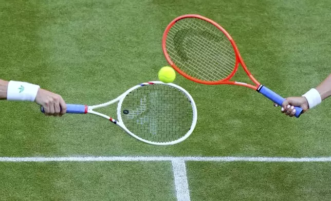 Joe Salisbury of Britain and Luisa Stefani of Brazil return the ball during the mixed doubles final match against Sem Verbeek of Netherland and Katerina Siniakova of Czech Republic at the Wimbledon Tennis Championships in London, Thursday, July 10, 2025. (AP Photo/Joanna Chan)