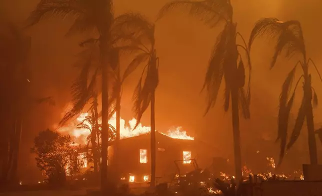 FILE - A home burns in the Eaton Fire in Altadena, Calif., Jan. 8, 2025. (AP Photo/Nic Coury, File)