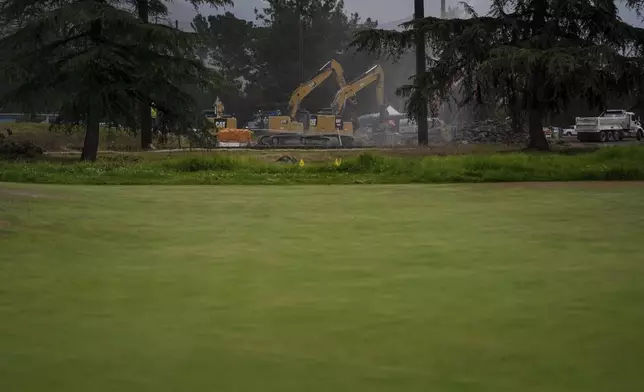Debris from January wildfires is processed at a recycling facility set up on a golf course in Altadena, Calif., Wednesday, June 4, 2025. (AP Photo/Jae C. Hong)