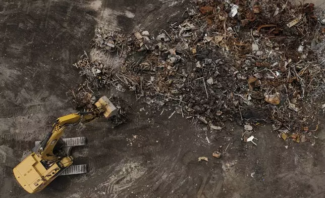 Debris from January wildfires is processed at a recycling facility set up on a golf course in Altadena, Calif., Wednesday, June 4, 2025. (AP Photo/Jae C. Hong)